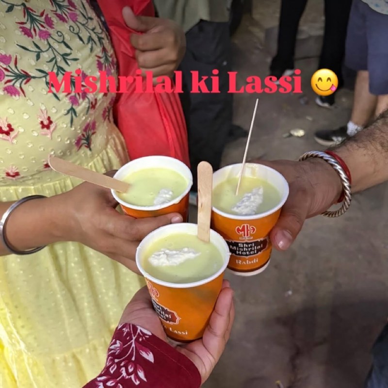 Guests raising cups of makhaniya lassi at Mishrilal