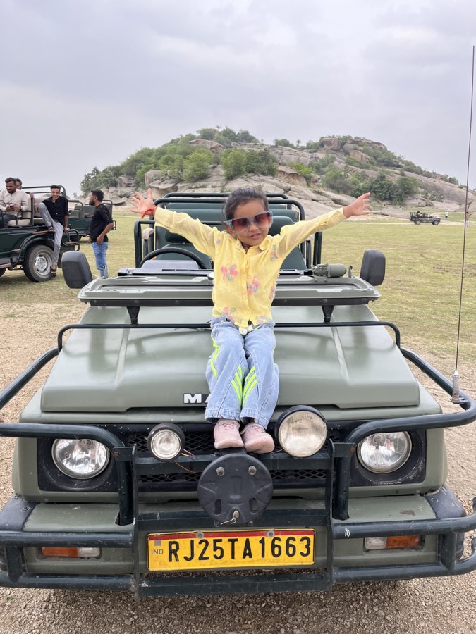 A young guest on the bonnet of a safari jeep in the Jawai hills