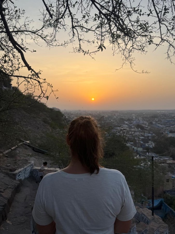 A guest watching the sun set over the Blue City