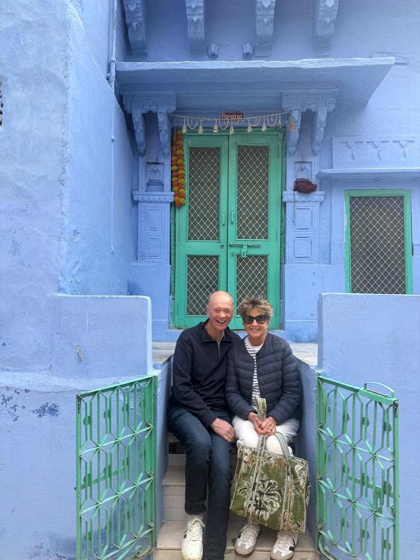 A green door set into a blue haveli
