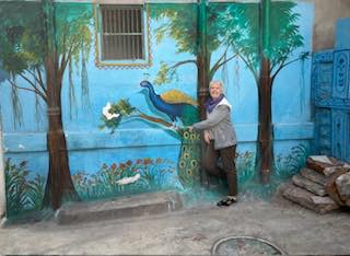 A peacock mural on a courtyard wall